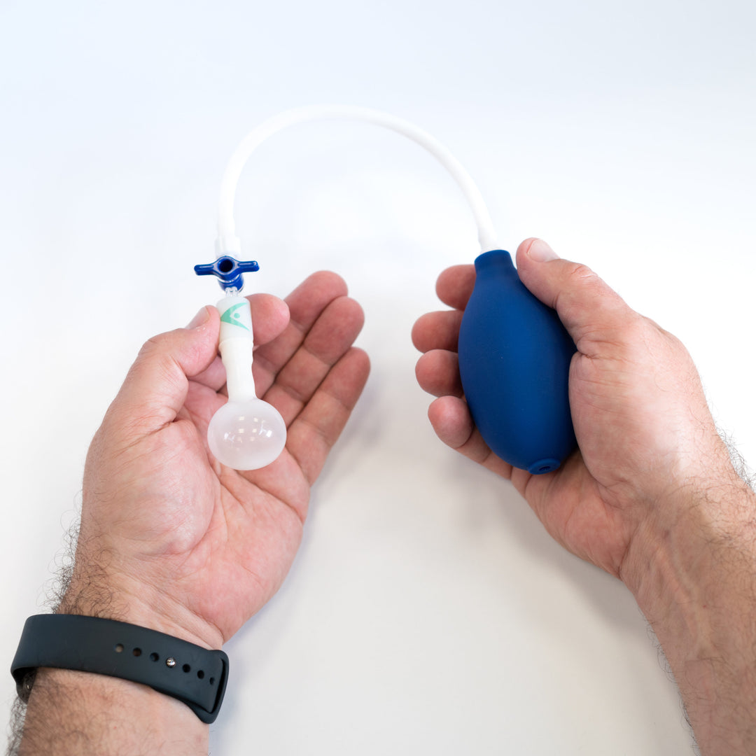 Man holding the Novoglan Squeeze Bulb Inflator System